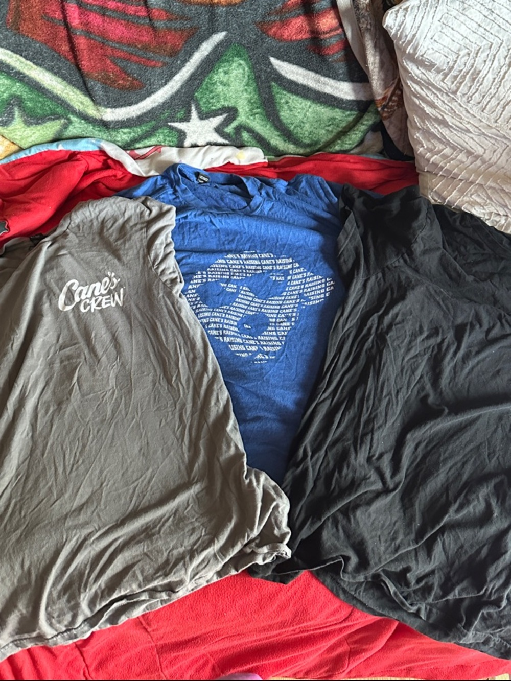 Raising Cane’s special edition crew shirts in blue, black and gray